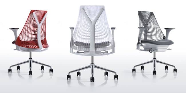 Three views of an ergonomic office chair with a mesh back and casters