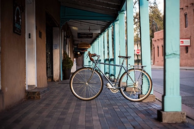 A bicycle parked in the column of a building in Santa Fe