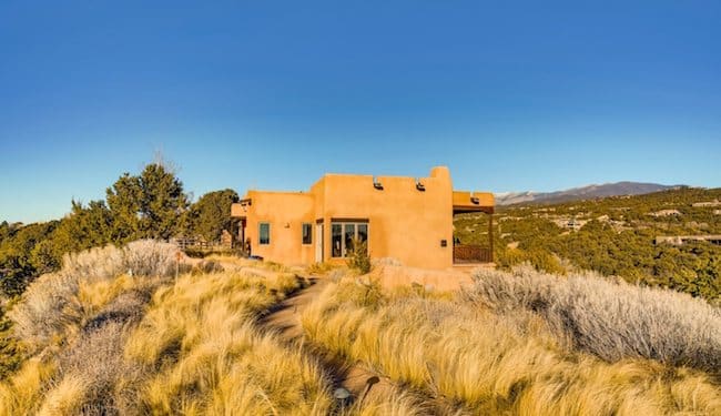 A Santa Fe home looking as if it sprang from nature, blending with the colors of the Santa Fe landscape.