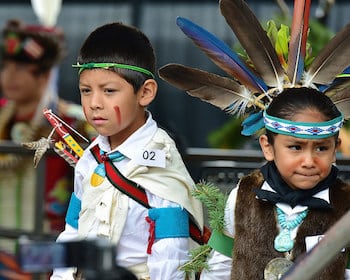 Two children wearing traditional Native American clothing at the Santa Fe Indian Market in Santa Fe, New Mexico