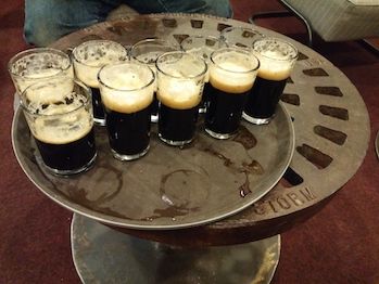 A table with a tray of beers