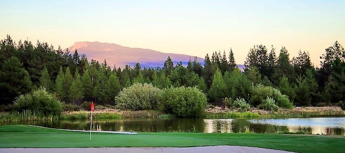 A view of a pond and a golf green at the Golf Quail Run course in Santa Fe, New Mexico.