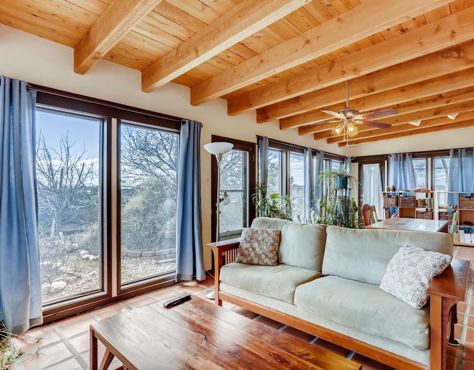 The living room of a home with large windows and a lot of light in Santa Fe