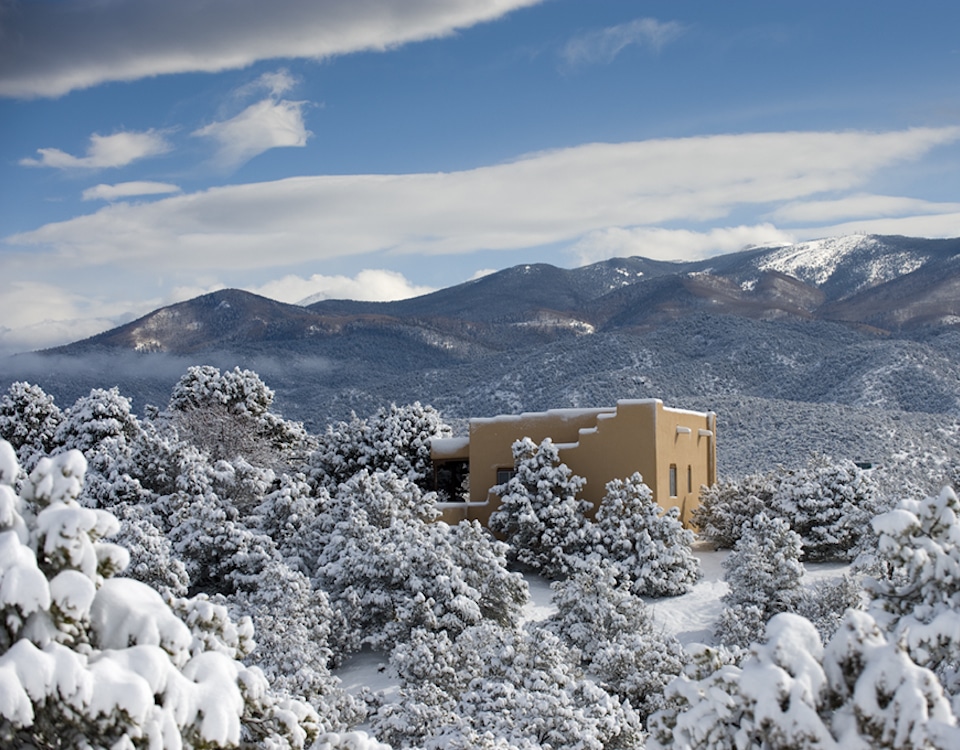 A home in Santa Fe covered in snow with a fantastic view of the Sangre de Cristo mountains