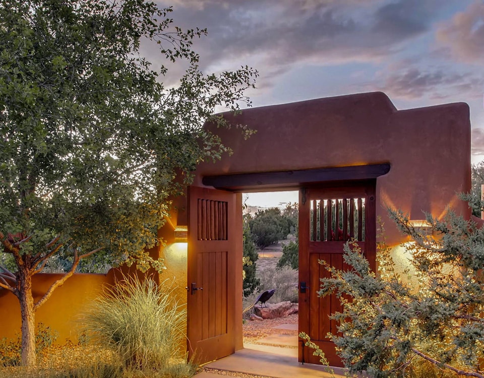 Adobe entryway to a Santa Fe home during sunset