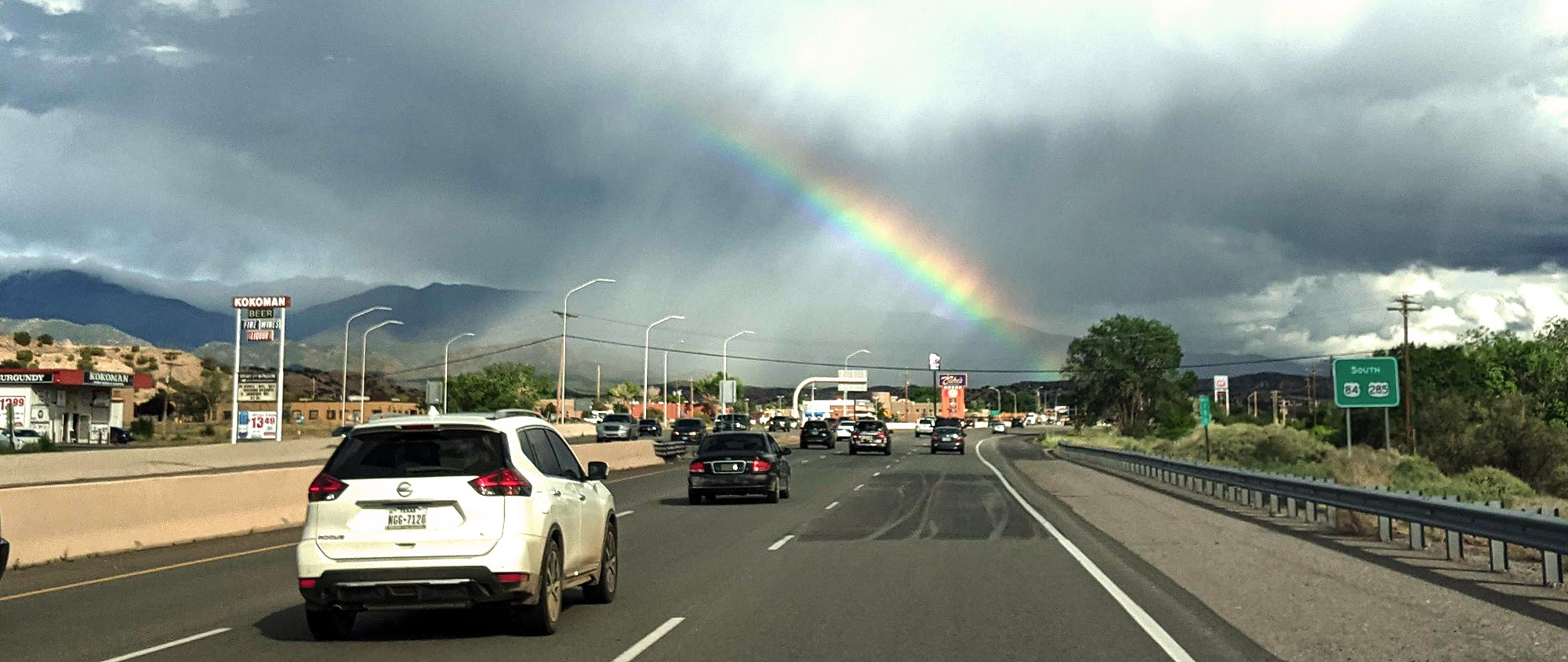 The beauty of Tesuque with walking rain and rainbow heading South into Santa Fe, New Mexico.