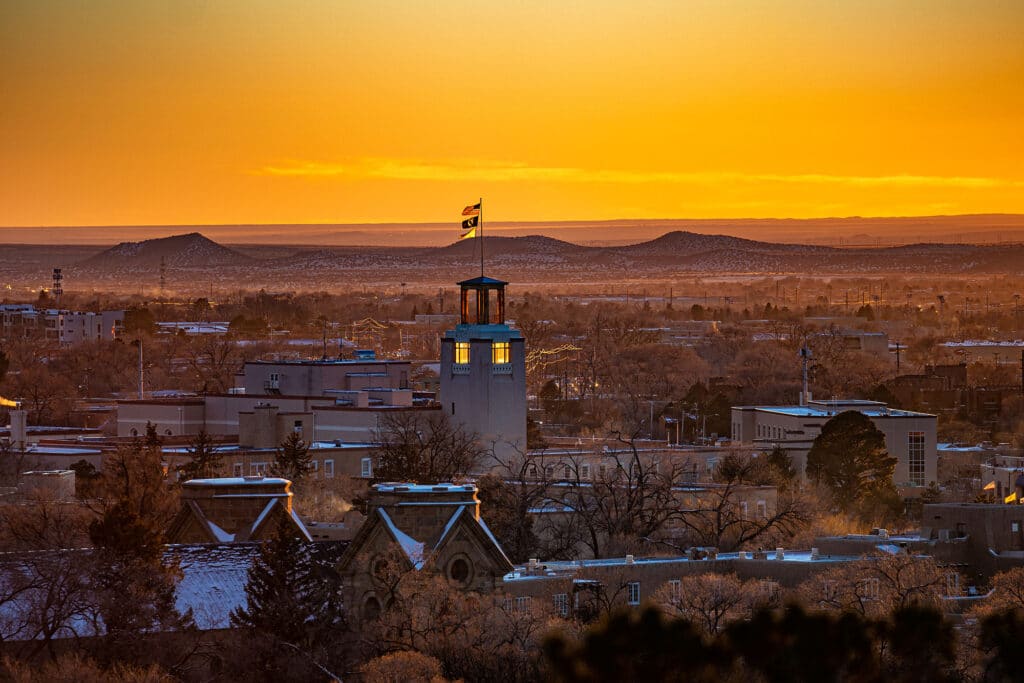 A view of adobe buildings lit by the setting sun in Santa Fe, New Mexico