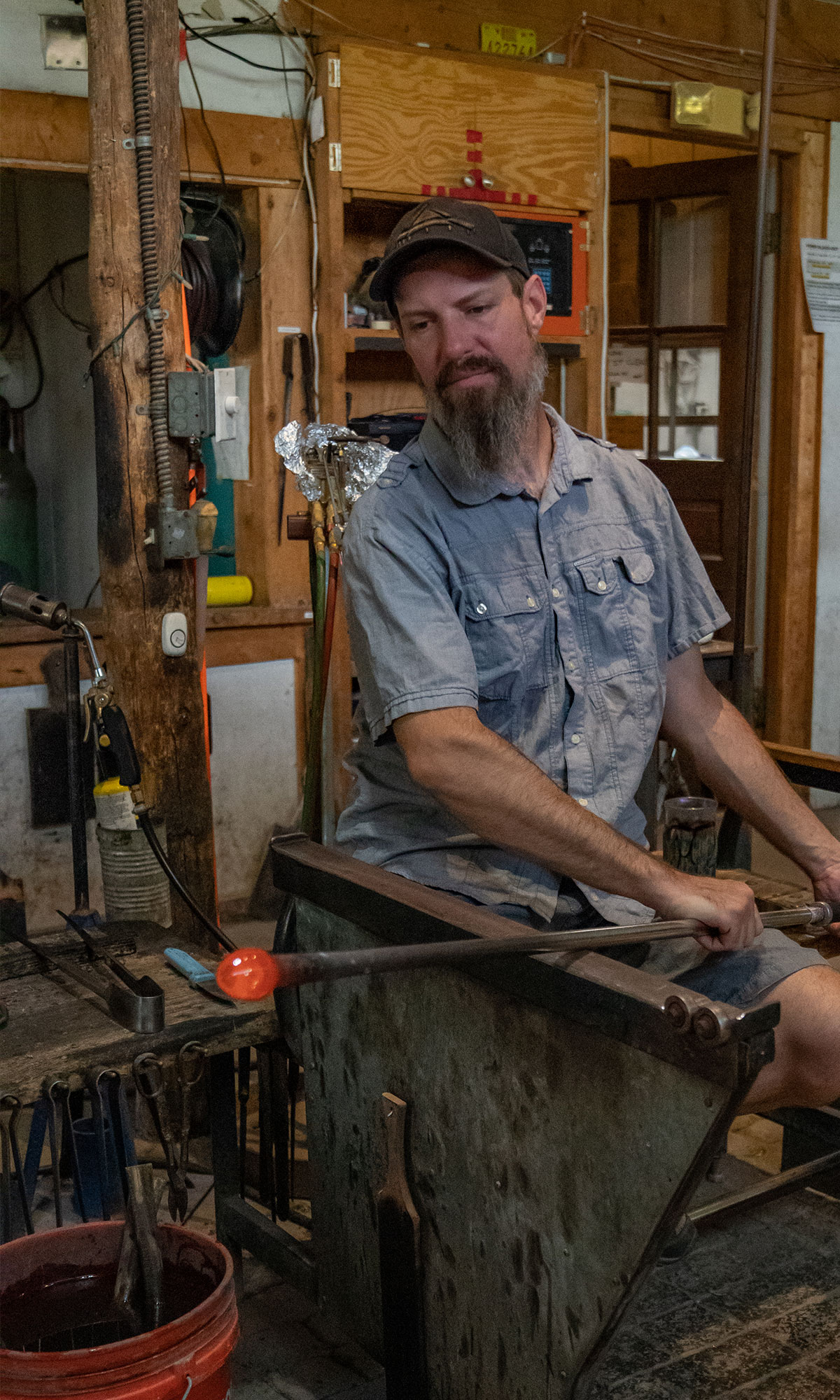 A glassmith or gaffer, blowing glass in Santa Fe, New Mexico.