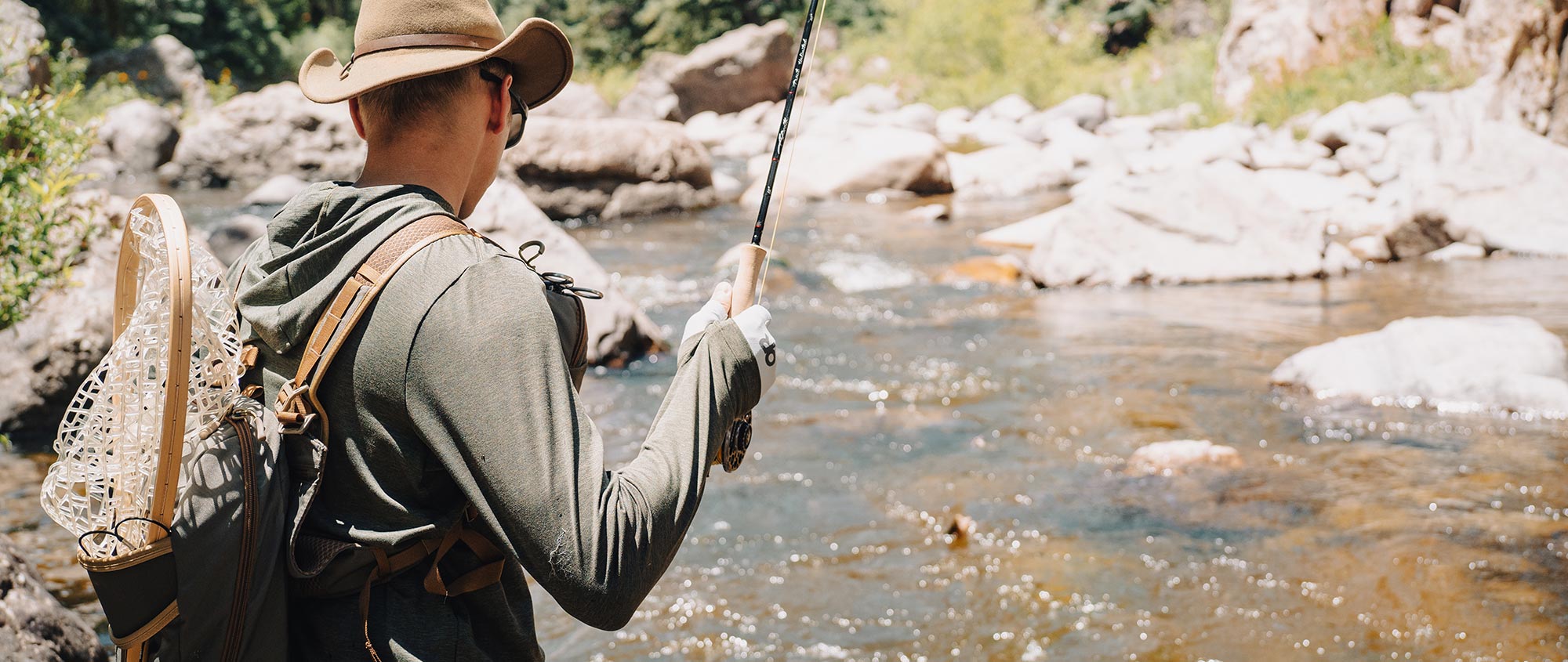 Man fly fishing stream in New Mexico.