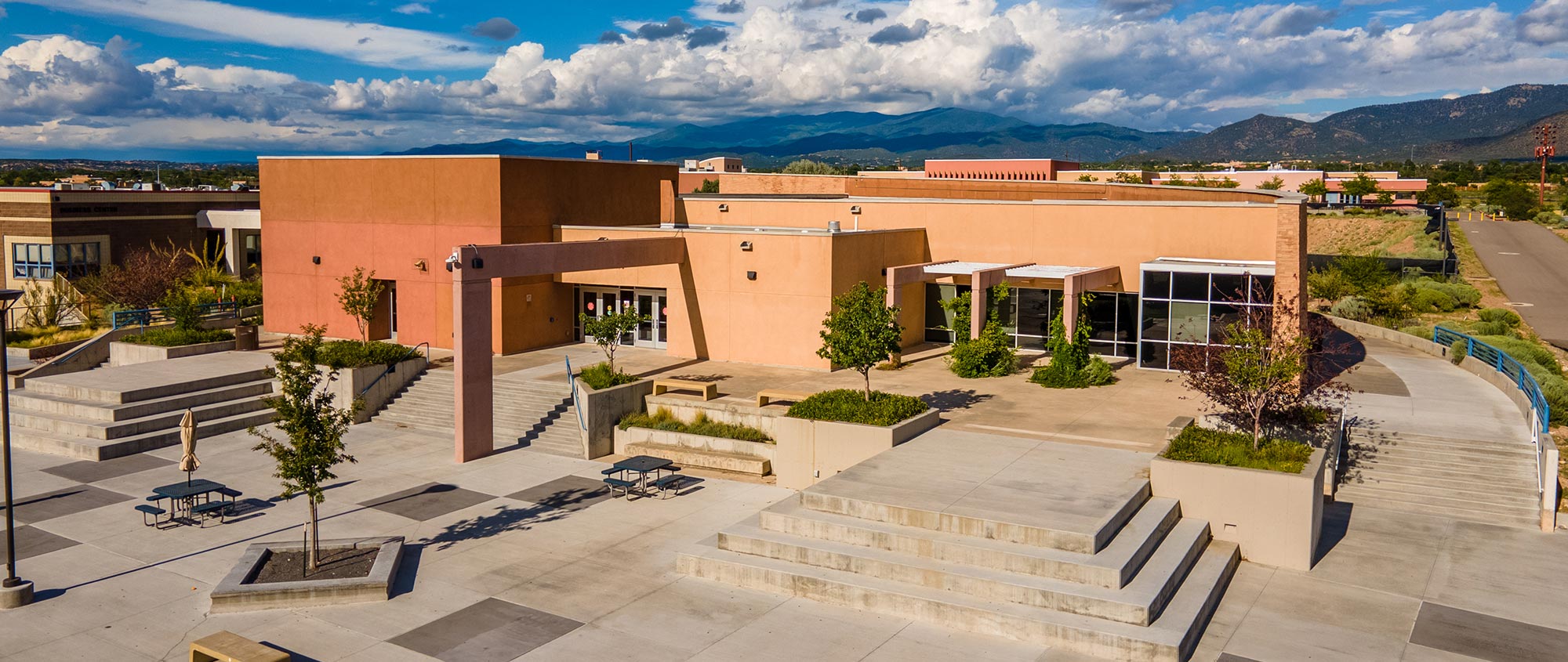 A Santa Fe Public School campus with mountains and clouds in the back ground in Santa Fe, NM