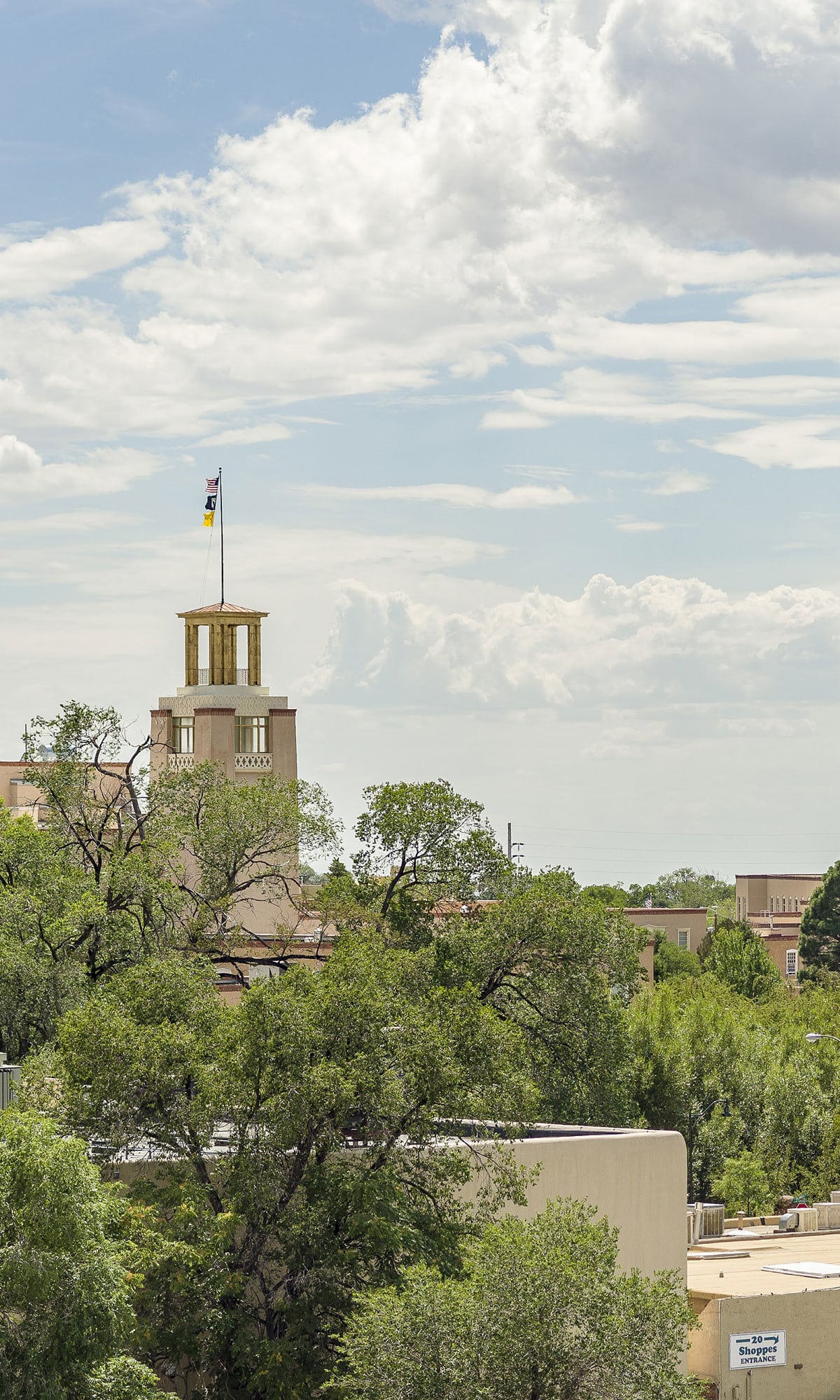 Flags fly from the top flag pole of the Bataan Memorial building in downtown Santa Fe, New Mexico.