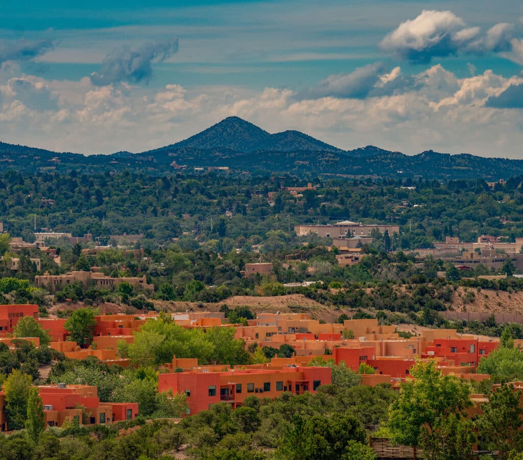 Open photo overlooking the colorful subdivision of Zocalo with mountains in the background. Santa Fe, NM.